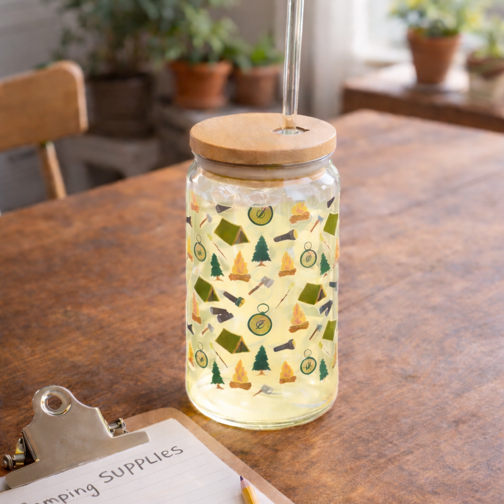 Luminescent jar with camping pattern on a wooden table next to a clipboard with a list.